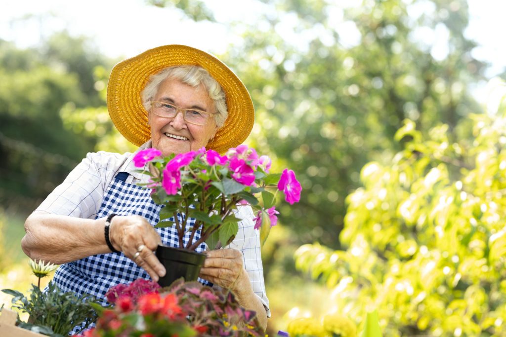 Senior residents enjoying a flower arrangement workshop sponsored by local businesses.